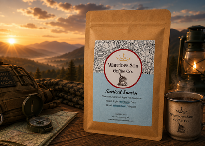 Warriors Son Coffee Co. package with sunset and camping gear in the background